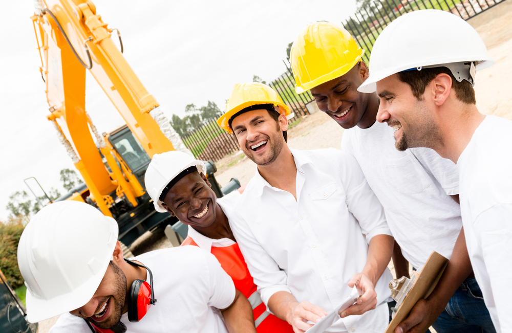 Happy group of workers laughing at a building site